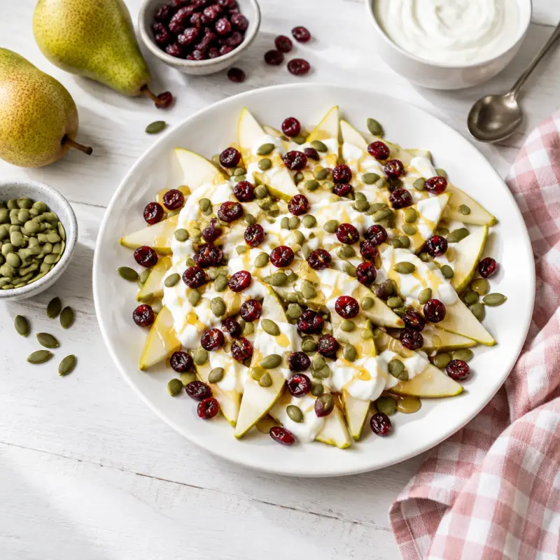 Pear "Nachos" with Greek Yogurt, Pumpkin Seeds, Cranberries & Honey, plated