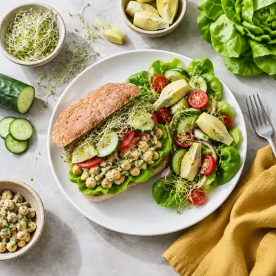 Mediterranean Chickpea Sandwich with Sprouts, Tomato & Side Salad