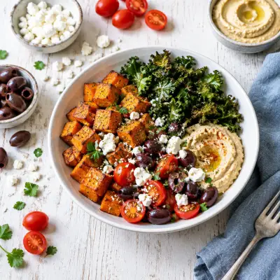 Roast Sweet Potato Bowl with Crispy Kale, Hummus, Olives & Feta